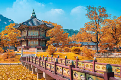 Gyeongbokgung Palace surrounded by autumn foliage in Seoul.