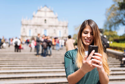 Young female student checking-in abroad, illustrating the importance of safety.