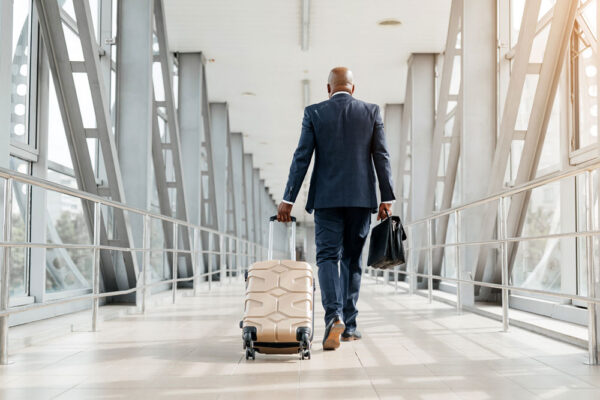 Executive Traveler Walking Through an International Airport Terminal