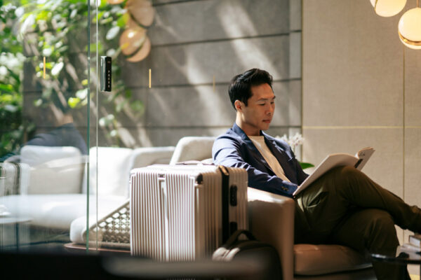 Business traveler reviewing a company travel policy before an international trip.