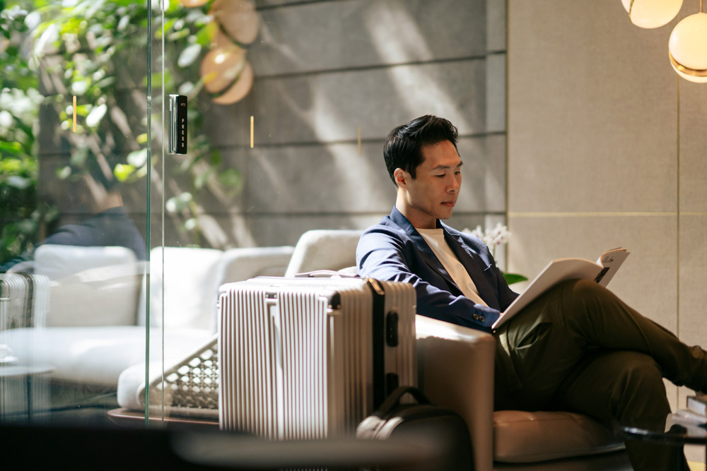 Business traveler reviewing a company travel policy before an international trip.