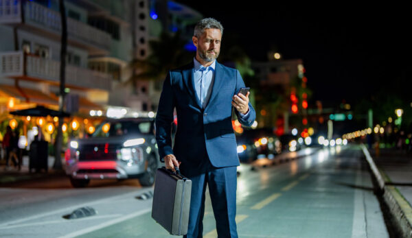 Business Traveler Reviewing a Security Alert as Protests Develop Nearby