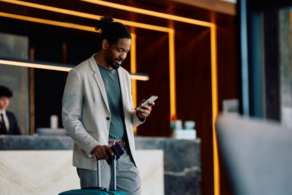 Employee checking in through a travel safety application while traveling for business.