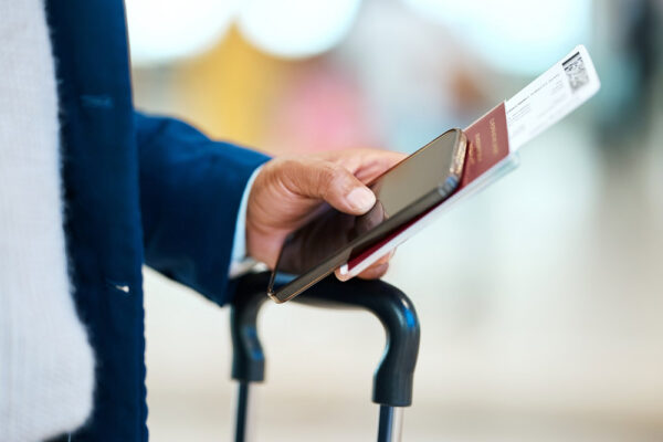 Employee Using a Business Travel Safety App while Traveling Abroad