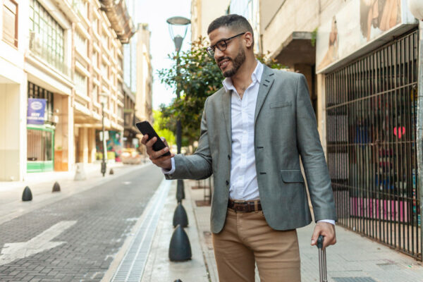 International Business Traveler Checking a Travel Security App