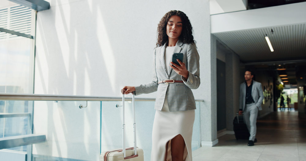 Business traveler using a mobile Check-In for employee accountability and travel safety abroad.