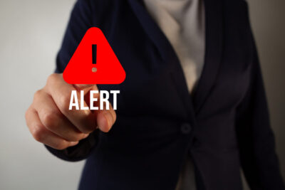 Business traveler activating an emergency alert.